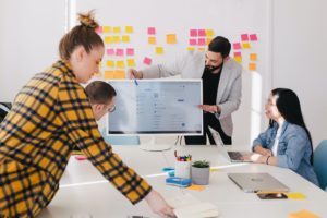 team sets goals on whiteboard to improve team performance 