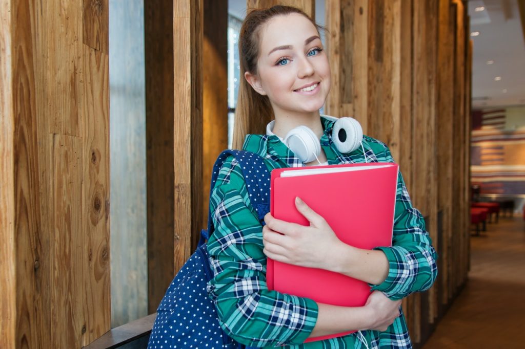 Student holding a pink binder